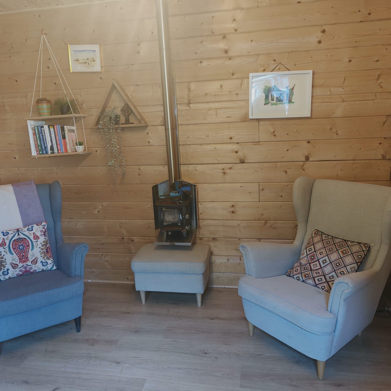 Two armchairs facing each other beside the wood stove